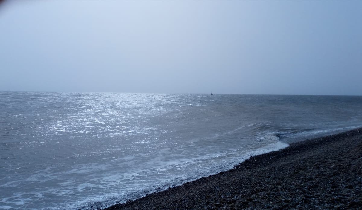 a beach view with shallow waves